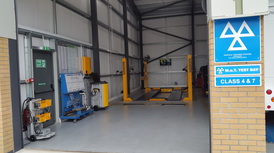 The open MOT test bay with the MOT sign and Class 4 and 7 signs beside the door
